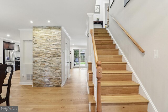 1367 Cedar Ave, Annapolis, MD 21403 - staircase with crown molding, wood finished floors, and recessed lighting