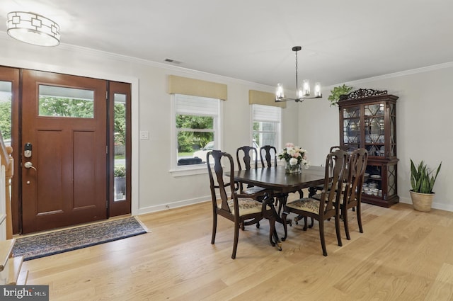 1367 Cedar Ave, Annapolis, MD 21403 - dining space with light wood finished floors, baseboards, a chandelier, and crown molding
