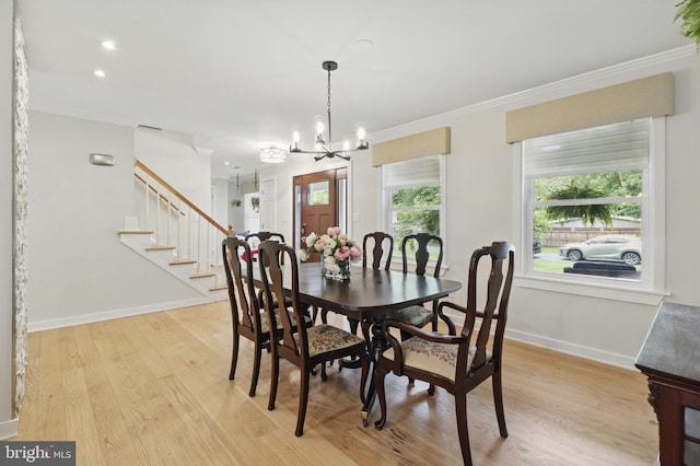 1367 Cedar Ave, Annapolis, MD 21403 - dining space featuring a chandelier, crown molding, light wood-style flooring, baseboards, and stairway