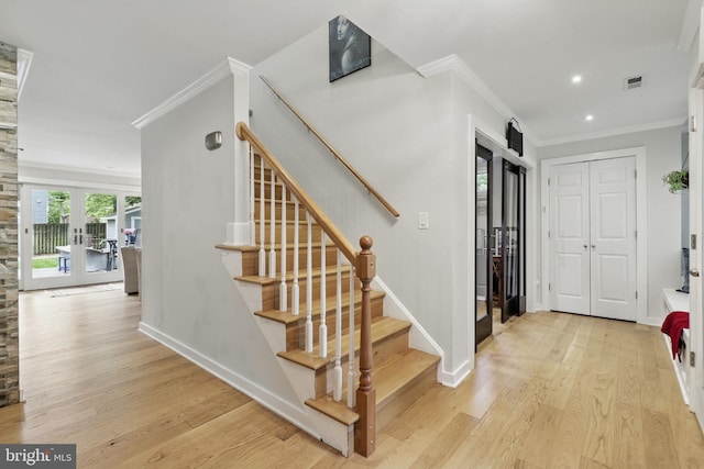 1367 Cedar Ave, Annapolis, MD 21403 - entryway featuring crown molding, light wood-style flooring, french doors, stairway, and baseboards