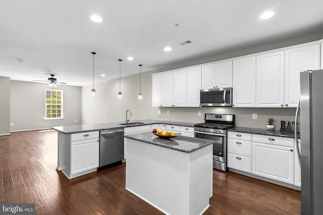 9778 Peace Springs Rdg, Laurel, MD 20723 - kitchen featuring stainless steel appliances, a peninsula, white cabinetry, recessed lighting, and ceiling fan