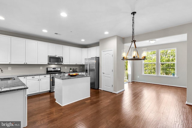 9778 Peace Springs Rdg, Laurel, MD 20723 - kitchen featuring appliances with stainless steel finishes, dark wood-style floors, a chandelier, white cabinetry, and recessed lighting