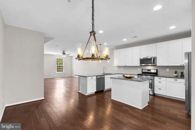 9778 Peace Springs Rdg, Laurel, MD 20723 - kitchen featuring stainless steel appliances, a chandelier, dark wood-type flooring, a center island, and a peninsula