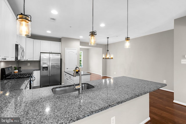 9778 Peace Springs Rdg, Laurel, MD 20723 - kitchen with appliances with stainless steel finishes, recessed lighting, dark stone counters, white cabinets, and a peninsula