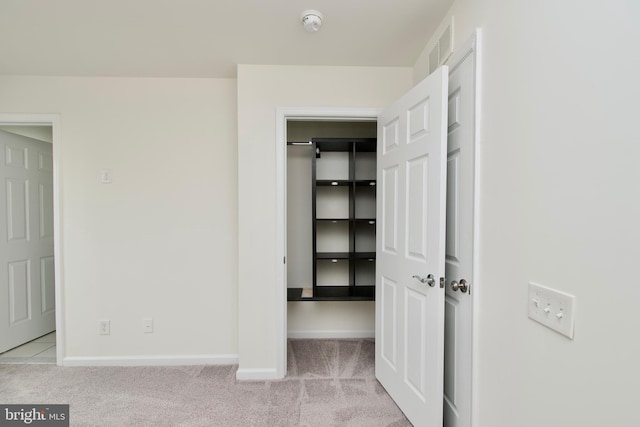 17023 Gibson Mill Rd, Dumfries, VA 22026 - unfurnished bedroom featuring a spacious closet, carpet flooring, baseboards, and a closet