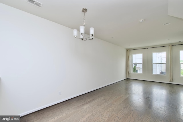 17023 Gibson Mill Rd, Dumfries, VA 22026 - unfurnished room featuring a chandelier, wood finished floors, a smoke detector, and baseboards