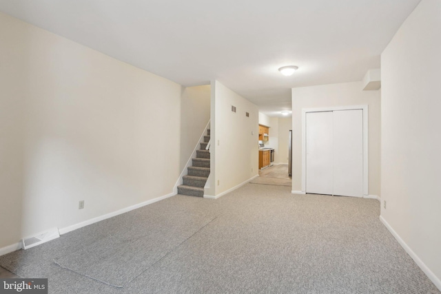 1018 W 7th St, Wilmington, DE 19805 - spare room featuring stairs, light carpet, and baseboards
