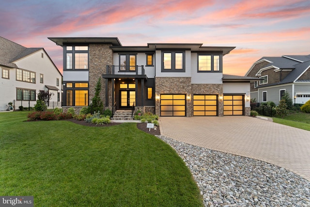 1554 Davidson Rd, Mclean, VA 22101 - contemporary house with a balcony, stone siding, decorative driveway, a lawn, and an attached garage