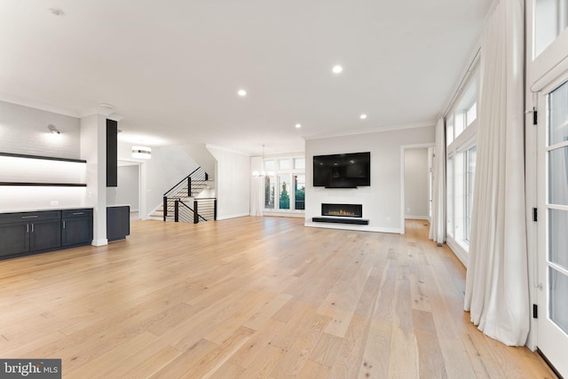 1554 Davidson Rd, Mclean, VA 22101 - unfurnished living room with stairway, light wood finished floors, crown molding, a lit fireplace, and recessed lighting