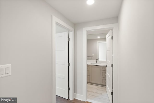 1554 Davidson Rd, Mclean, VA 22101 - hallway with a sink, light wood-type flooring, recessed lighting, and baseboards