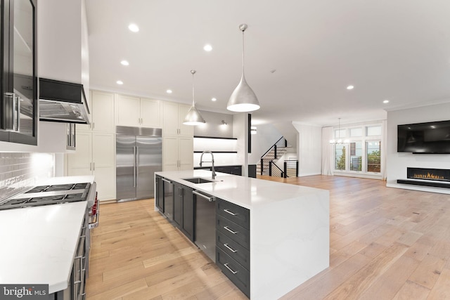 1554 Davidson Rd, Mclean, VA 22101 - kitchen with high end appliances, a sink, white cabinets, light countertops, and decorative backsplash
