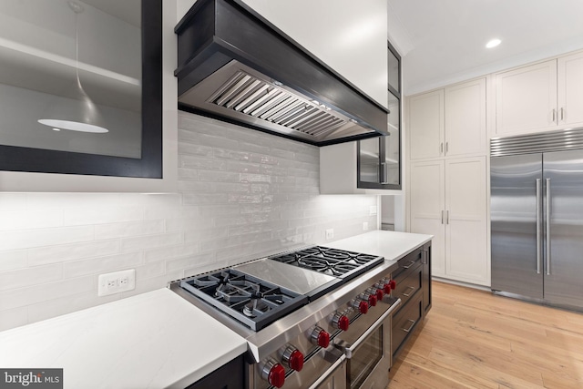 1554 Davidson Rd, Mclean, VA 22101 - kitchen featuring high quality appliances, custom range hood, light countertops, decorative backsplash, and light wood-style floors
