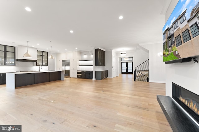 1554 Davidson Rd, Mclean, VA 22101 - unfurnished living room featuring recessed lighting, a glass covered fireplace, light wood-style floors, ornamental molding, and baseboards