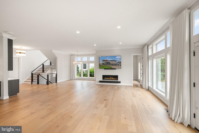 1554 Davidson Rd, Mclean, VA 22101 - unfurnished living room featuring a lit fireplace, healthy amount of natural light, light wood-style flooring, crown molding, and baseboards