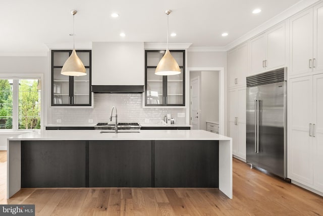 1554 Davidson Rd, Mclean, VA 22101 - kitchen featuring built in fridge, ornamental molding, light countertops, backsplash, and extractor fan
