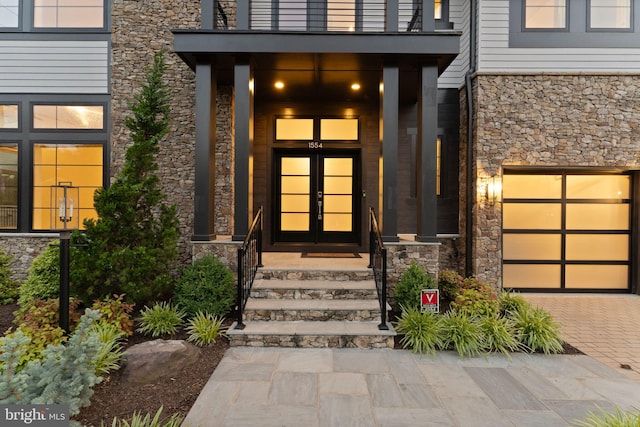 1554 Davidson Rd, Mclean, VA 22101 - entrance to property with french doors, stone siding, decorative driveway, and a garage