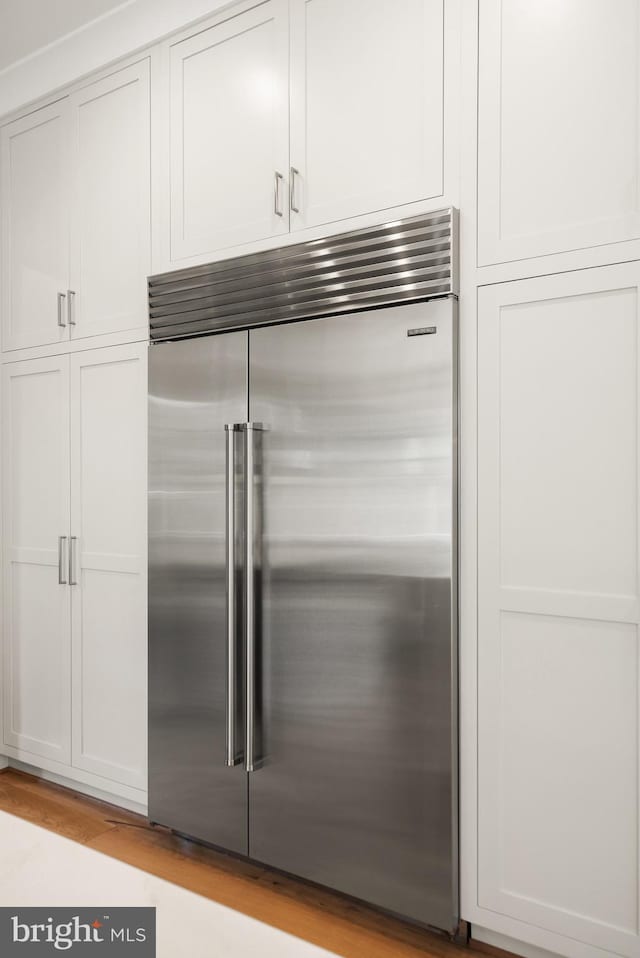 1554 Davidson Rd, Mclean, VA 22101 - kitchen view of built in refrigerator, light wood-type flooring, and white cabinetry