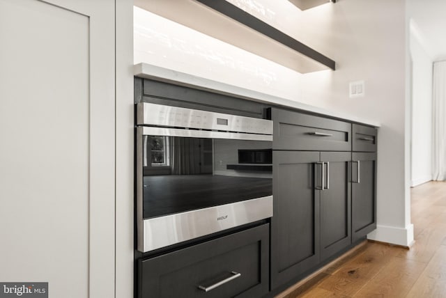 1554 Davidson Rd, Mclean, VA 22101 - kitchen with wood finished floors, gray cabinetry, and baseboards
