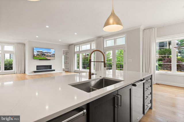 1554 Davidson Rd, Mclean, VA 22101 - kitchen with open floor plan, a sink, light countertops, a glass covered fireplace, and light wood-style floors