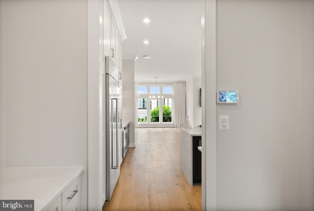 1554 Davidson Rd, Mclean, VA 22101 - hall with light wood finished floors, a chandelier, and recessed lighting