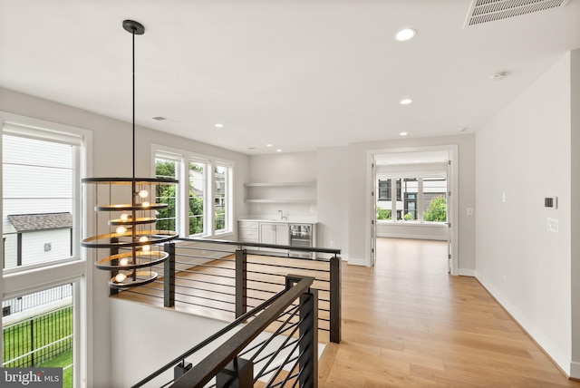 1554 Davidson Rd, Mclean, VA 22101 - hall with an upstairs landing, light wood-style floors, healthy amount of natural light, recessed lighting, and baseboards