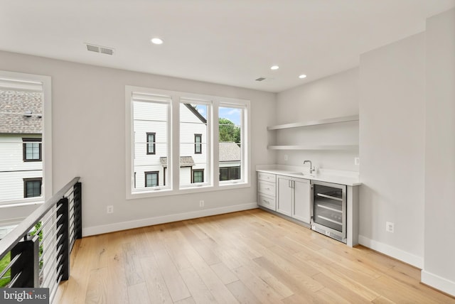 1554 Davidson Rd, Mclean, VA 22101 - indoor wet bar with wine cooler, light wood finished floors, baseboards, and recessed lighting