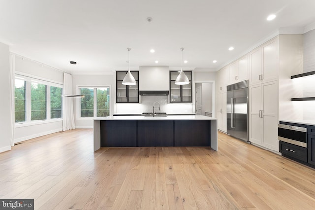 1554 Davidson Rd, Mclean, VA 22101 - kitchen featuring stainless steel built in refrigerator, custom exhaust hood, oven, light countertops, and a large island with sink