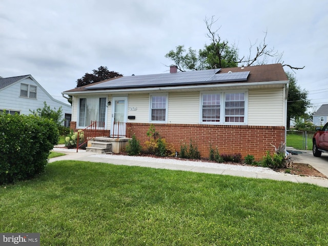 1808 Wentworth Rd, Baltimore, MD 21234 - bungalow featuring brick siding, a front yard, roof mounted solar panels, and a chimney