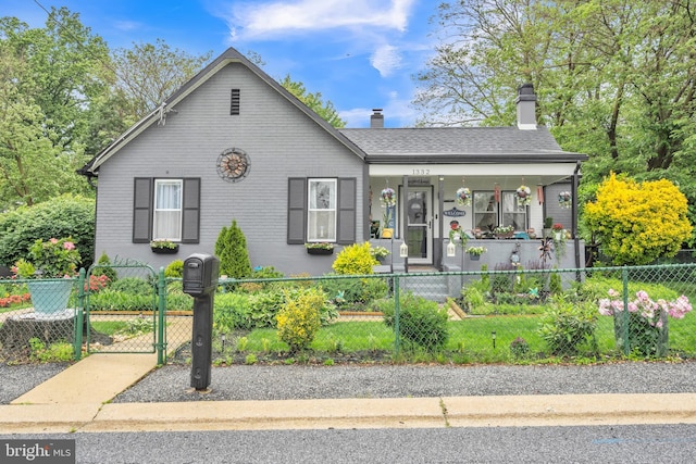 1332 Peach St, Upper Chichester, PA 19061 - view of front of home featuring a porch, a chimney, brick siding, a fenced front yard, and a gate