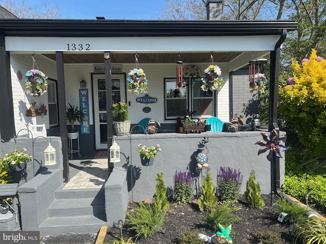 1332 Peach St, Upper Chichester, PA 19061 - entrance to property featuring a porch, a chimney, and brick siding