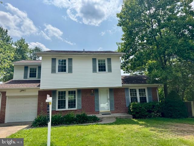 2502 Dover Ct, Woodbridge, VA 22192 - view of front of property featuring brick siding, a front yard, driveway, and an attached garage
