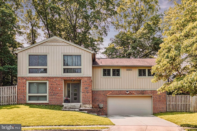 5425 Aylor Rd, Fairfax, VA 22032 - tri-level home featuring an attached garage, concrete driveway, brick siding, and board and batten siding