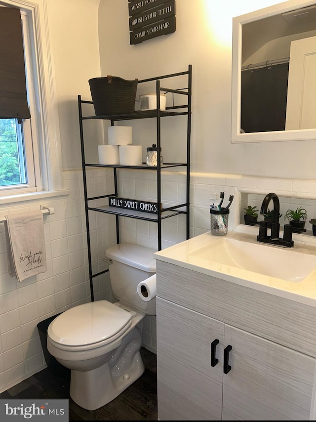3018 Joshua Rd, Lafayette Hill, PA 19444 - bathroom featuring tile walls, vanity, toilet, and a wainscoted wall