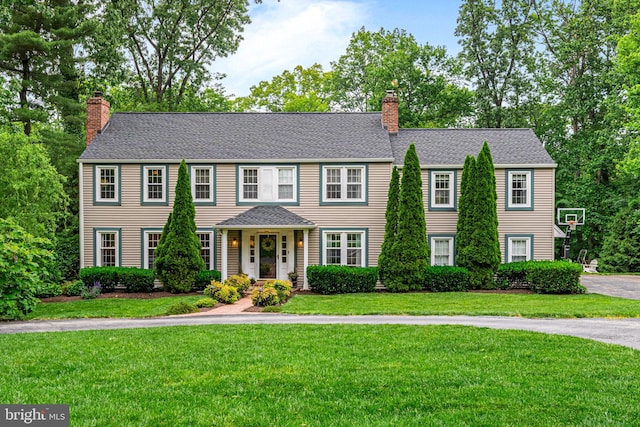 363 Colket Ln, Wayne, PA 19087 - colonial-style house with a chimney, a front yard, and roof with shingles