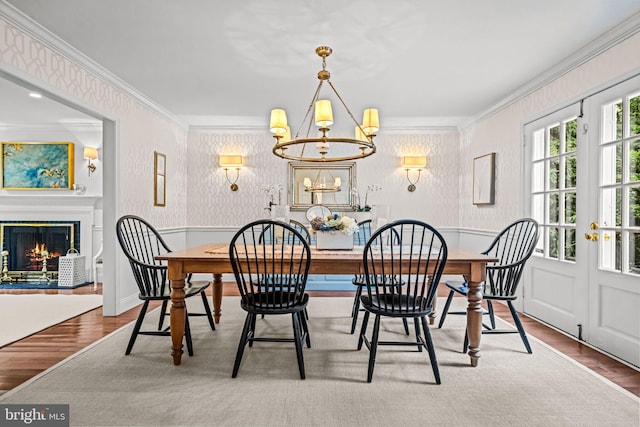 363 Colket Ln, Wayne, PA 19087 - dining room with wood finished floors, ornamental molding, a chandelier, wainscoting, and wallpapered walls