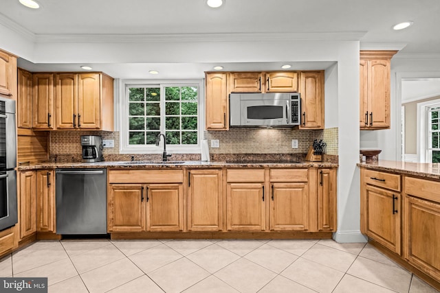 363 Colket Ln, Wayne, PA 19087 - kitchen with stainless steel appliances, a sink, dark stone counters, tasteful backsplash, and crown molding