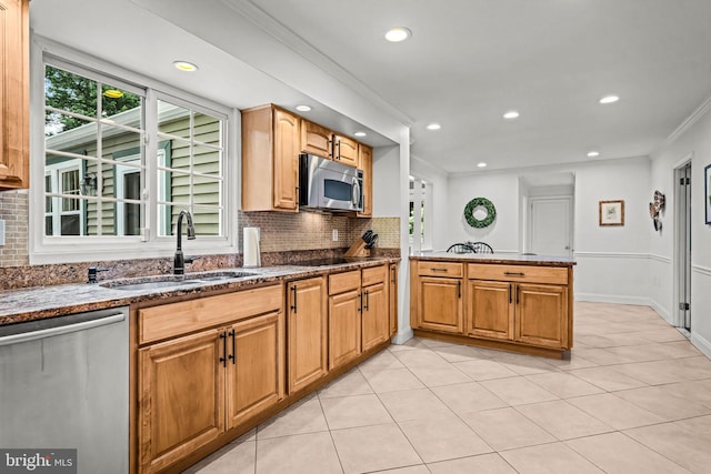 363 Colket Ln, Wayne, PA 19087 - kitchen featuring appliances with stainless steel finishes, a sink, backsplash, dark stone counters, and crown molding