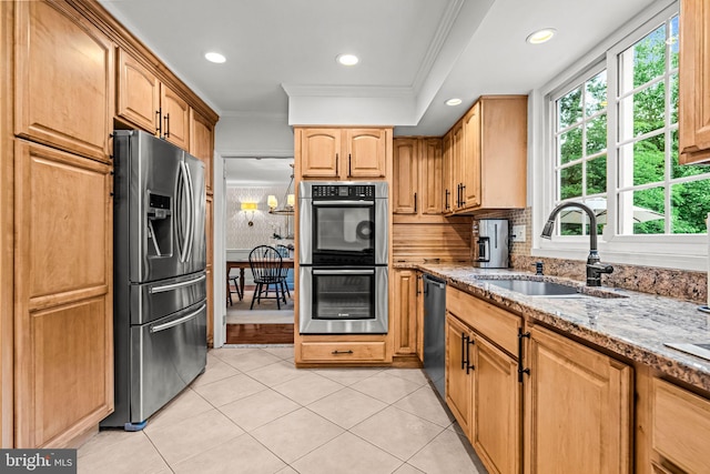 363 Colket Ln, Wayne, PA 19087 - kitchen with stainless steel appliances, ornamental molding, a sink, light stone counters, and light tile patterned floors