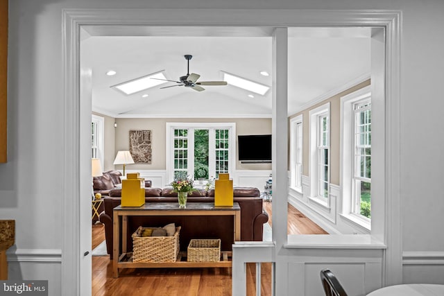 363 Colket Ln, Wayne, PA 19087 - living room with a skylight, a decorative wall, plenty of natural light, wainscoting, and wood finished floors