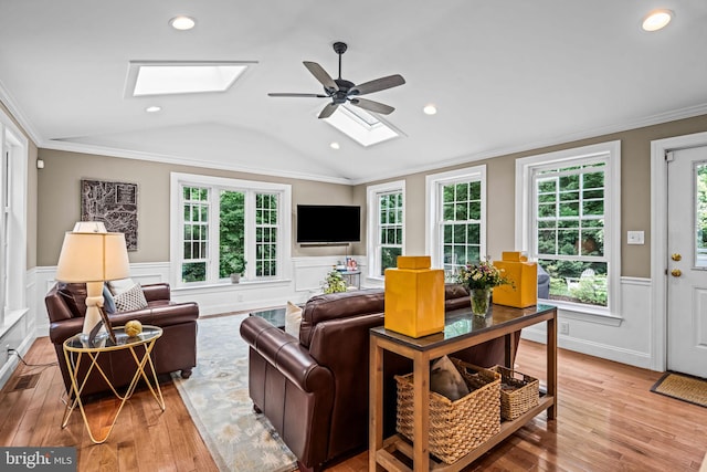 363 Colket Ln, Wayne, PA 19087 - living area featuring a skylight, wood-type flooring, a wainscoted wall, a ceiling fan, and crown molding