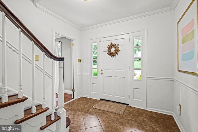 363 Colket Ln, Wayne, PA 19087 - foyer with healthy amount of natural light, ornamental molding, stairway, dark tile patterned flooring, and baseboards