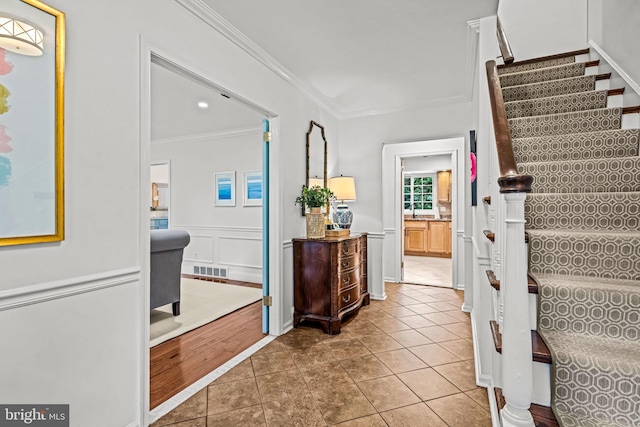 363 Colket Ln, Wayne, PA 19087 - stairs with ornamental molding, tile patterned flooring, and wainscoting