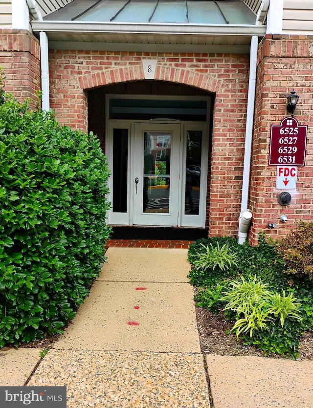 6527 Grange Ln Unit 202, Alexandria, VA 22315 - doorway to property with brick siding
