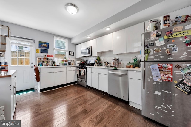2112 Watkins St, Philadelphia, PA 19145 - kitchen with stainless steel appliances, dark wood-type flooring, white cabinetry, light countertops, and recessed lighting
