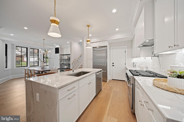 5376 28th St NW, Washington, DC 20015 - kitchen featuring a sink, high quality appliances, crown molding, light wood finished floors, and white cabinetry