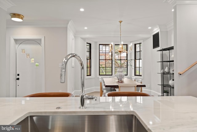 5376 28th St NW, Washington, DC 20015 - kitchen featuring a sink, crown molding, baseboards, recessed lighting, and light stone counters