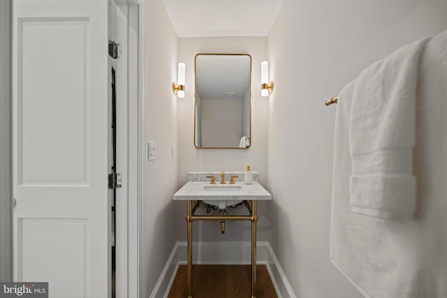 5376 28th St NW, Washington, DC 20015 - bathroom with baseboards and wood finished floors