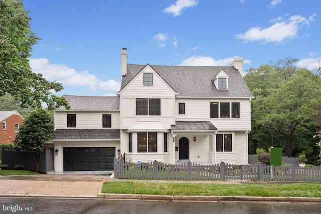 5376 28th St NW, Washington, DC 20015 - view of front of home with driveway, a fenced front yard, an attached garage, a shingled roof, and stone siding