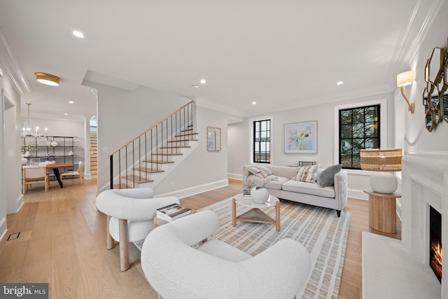 5376 28th St NW, Washington, DC 20015 - living room featuring stairway, light wood-style flooring, crown molding, recessed lighting, and a premium fireplace