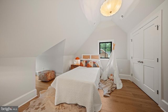 5376 28th St NW, Washington, DC 20015 - bedroom with lofted ceiling, wood finished floors, and baseboards